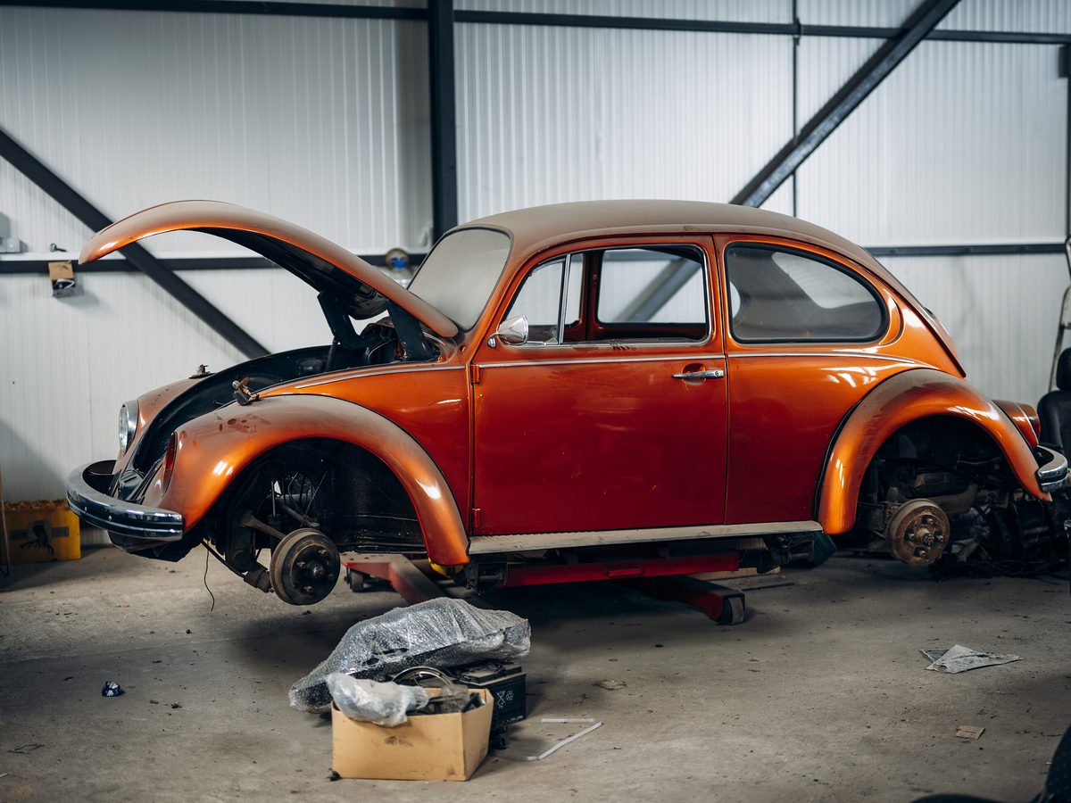Classic Beetle mid-restoration on a lift, wheels off and hood open. Photo: Shixart1985, CC BY 2.0, via Wikimedia Commons