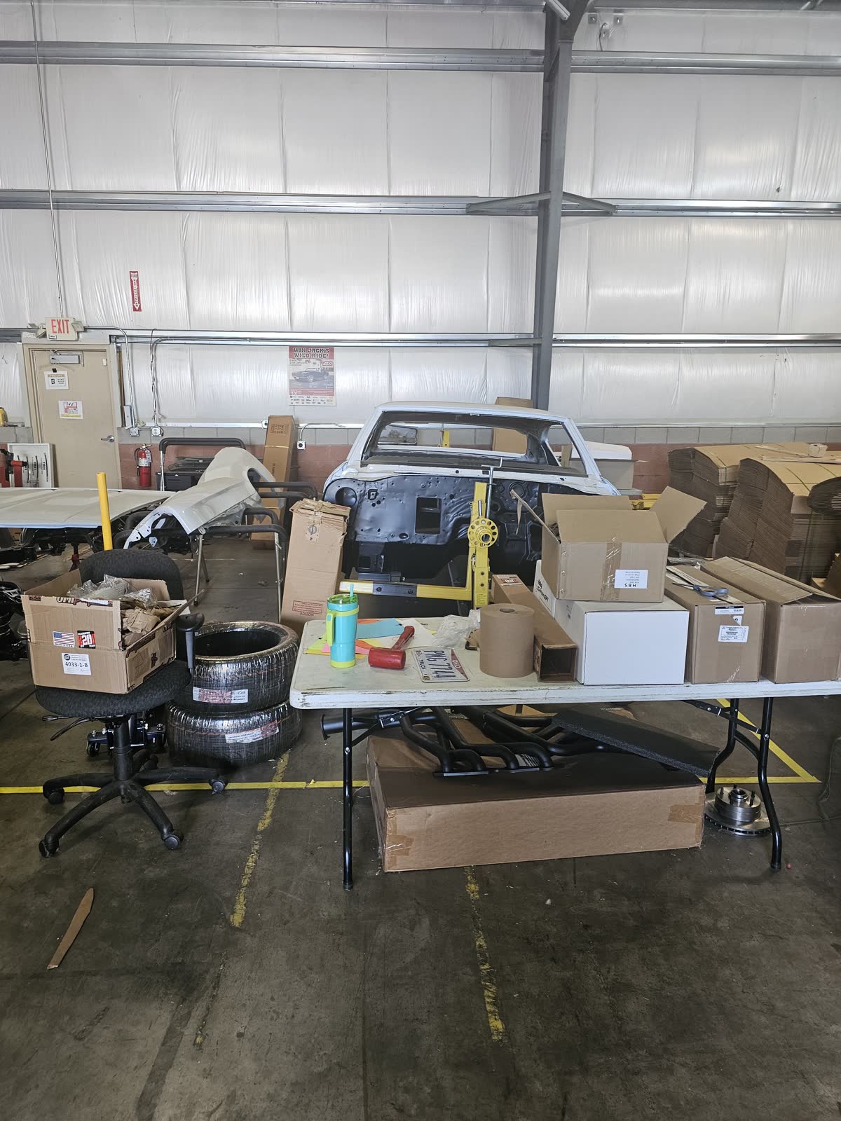 Parts table and F-body shell staged for phased restoration work